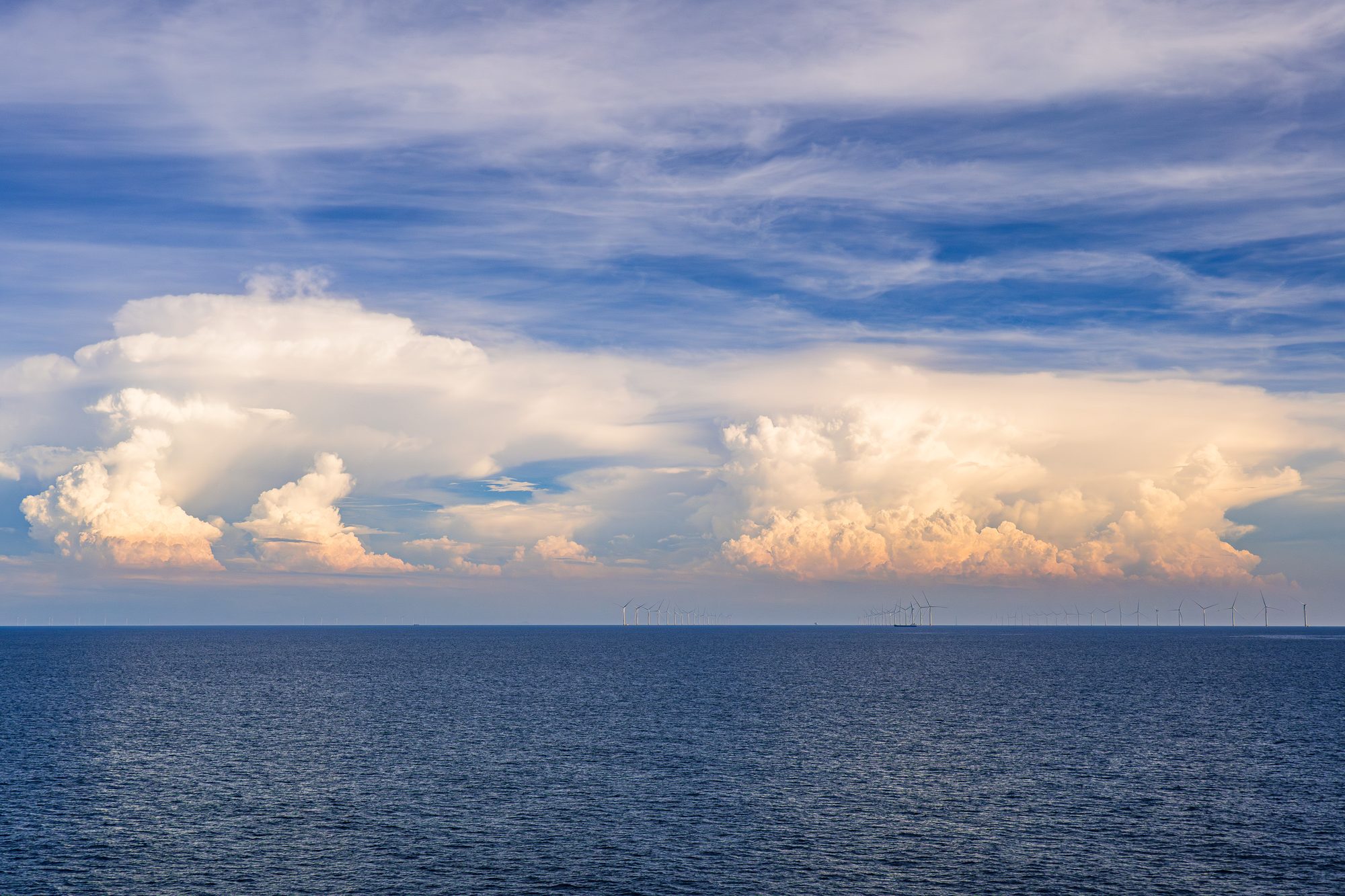 Distant wind turbines on the horizon, Hainan Strait